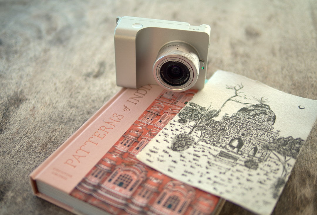 Caira in silver resting on an illustrated book
