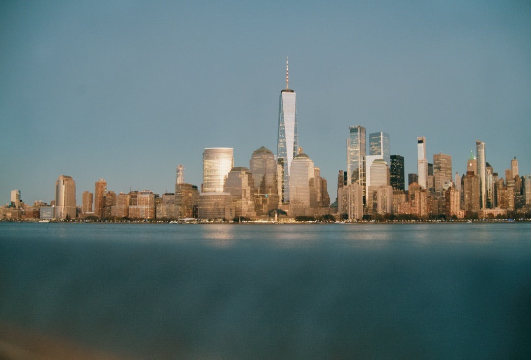 Lower Manhattan skyline at dusk across the Hudson, shot at ISO 4289 — captured with Caira