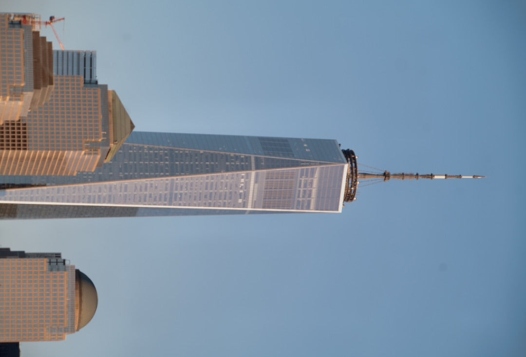 One World Trade Center rising above neighbouring rooftops — captured with Caira
