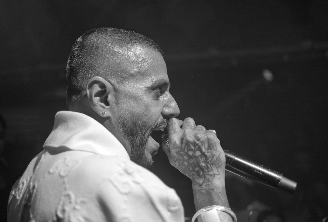 Black-and-white portrait of a vocalist performing, captured with Caira