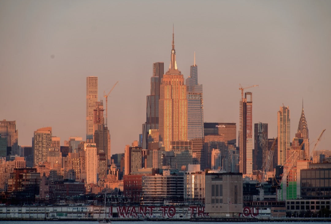 Empire State Building in warm sunset light across the Hudson