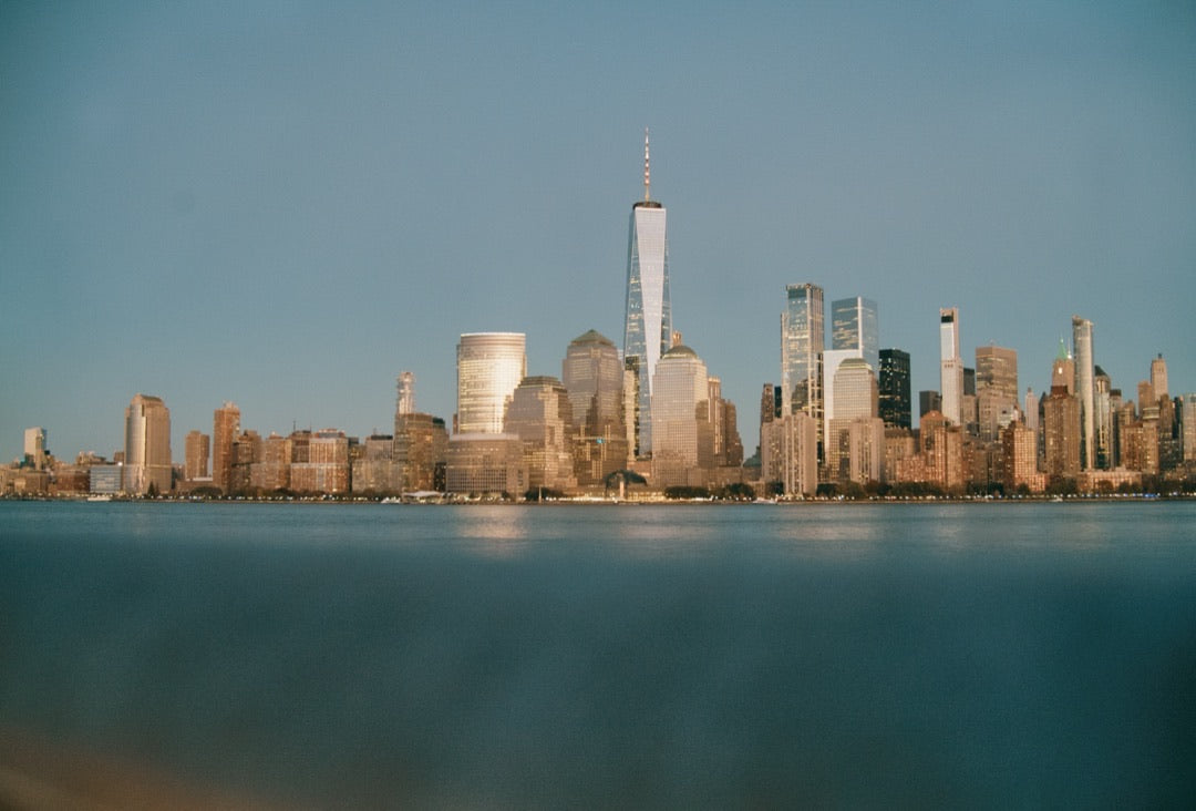 Lower Manhattan skyline at dusk across the Hudson, shot at ISO 4289
