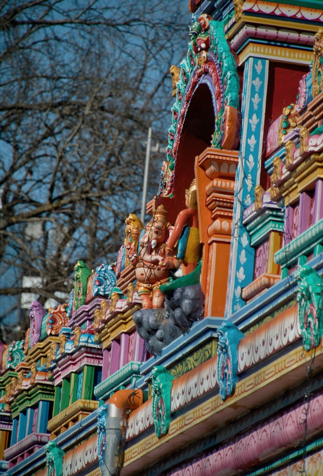 Brightly painted figures on a Hindu temple facade